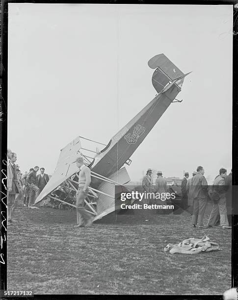 Spectators at Roosevelt Field examine wrecked Curtis Fledging biplane in which Howard Wong, a 25-year-old Chinese aviation student crashed. Wong was...