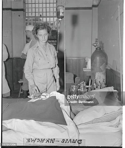 1st Lt. Rebecca L. Schmidt, Army nurse from Long Green, DD., takes good care of her patient, Hideki Tojo, who attempted suicide, for the Allied want...