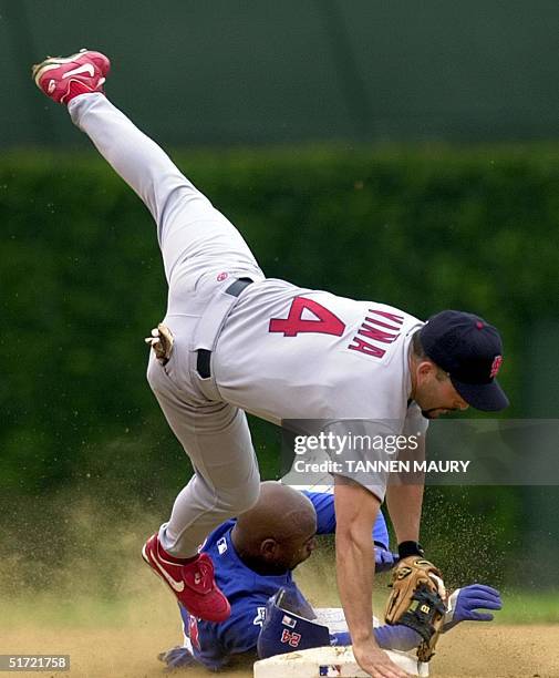 Chicago Cubs outfielder Michael Tucker upends St. Louis Cardinals second baseman Fernando Vina in the first inning 25 August at Wrigley Field in...
