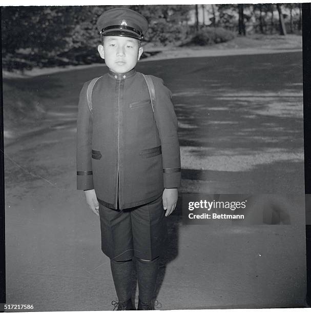 Heir to the Jap Throne. Tokyo, Japan: Young Crown Prince Akihito, heir to the Jap throne, poses for an ACME Newspictures' cameraman on his way home...