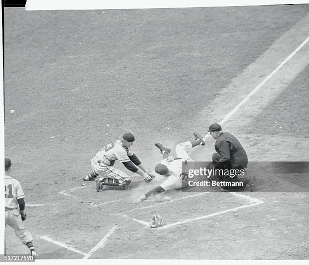 Hank Sauer of the Cubs slides hand-first across home plate, to score from second on Andy Pafko's 2nd inning single against the Braves, May 10. Boston...