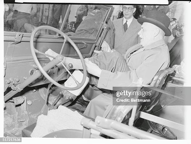 Prime Minister Visits Winnipeg. Winnipeg, Manitoba, Canada: Louis St. Laurent, prime minister of Canada, dons heavy socks before touring the Wildwood...