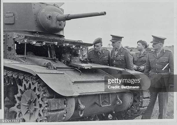 Australian army officers, including Captain Fletcher and General Northcott, Commanding Officer of Australia, examine an American-made army tank in...