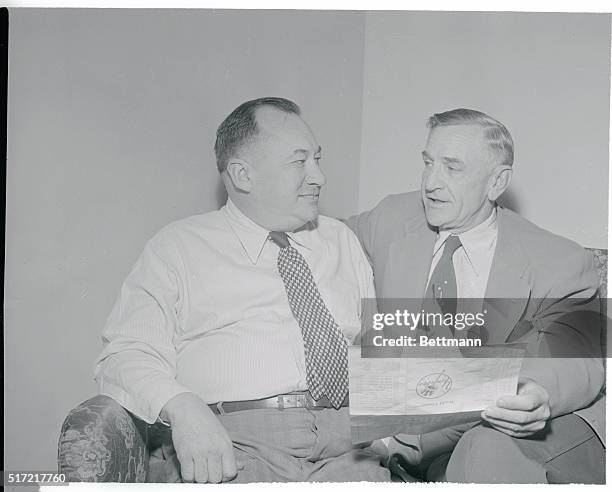 Manager Casey Stengel of the New York Yankees and general manager George Weiss look over a list of the unsigned players at the club's spring training...