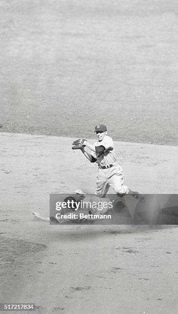 First baseman Johnny Sturm of the New York Yankees, who had singled for the first hit of the 1941 World Series, is forced out at second base on third...