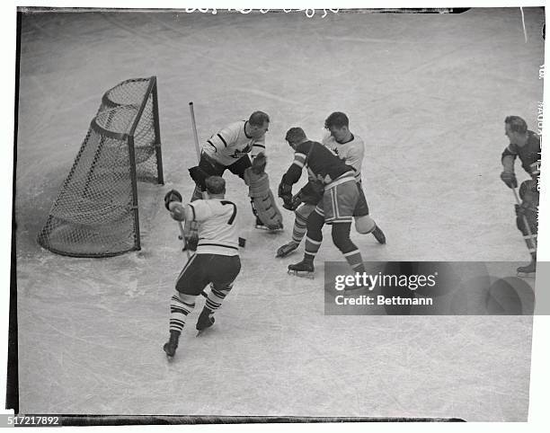 On a pass from Neil Colville, Lynn Patrick of the New York Rangers rams the puck home for a score against the Toronto Maple Leafs at Madison Square...