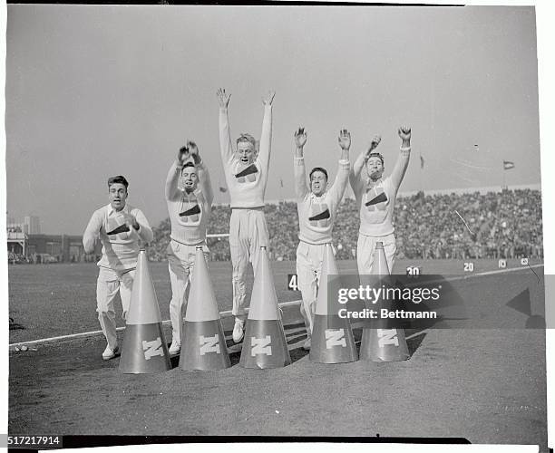 Naval Academy cheer leaders lead the student body during the annual Army-Navy game in the Municipal Stadium here. Navy won 14 to 6, left to right are...