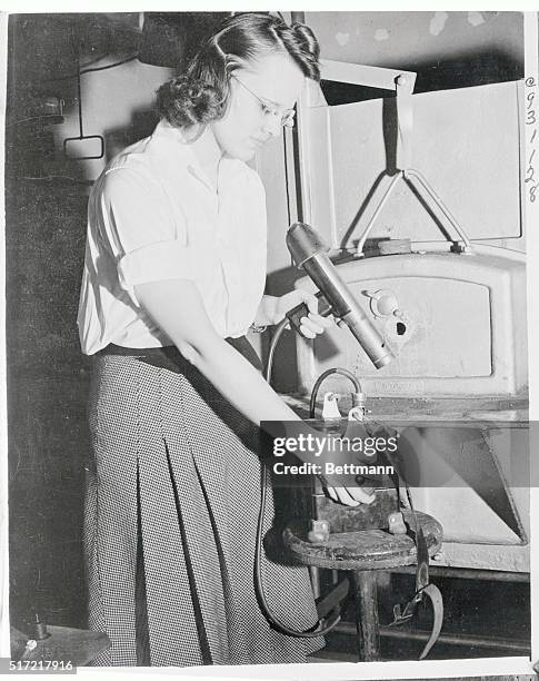 Pictured at work in the General Electric Research Laboratory in Schenectady is Catherine Ferguson, 1940 graduate of Northwestern University, who is...