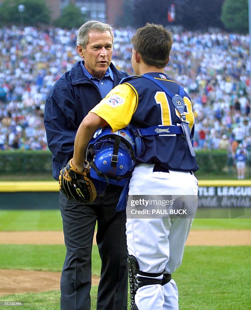 US President George W. Bush receives the baseball