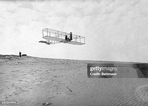 Orville Wright flies a glider over Kill Devil Hills.