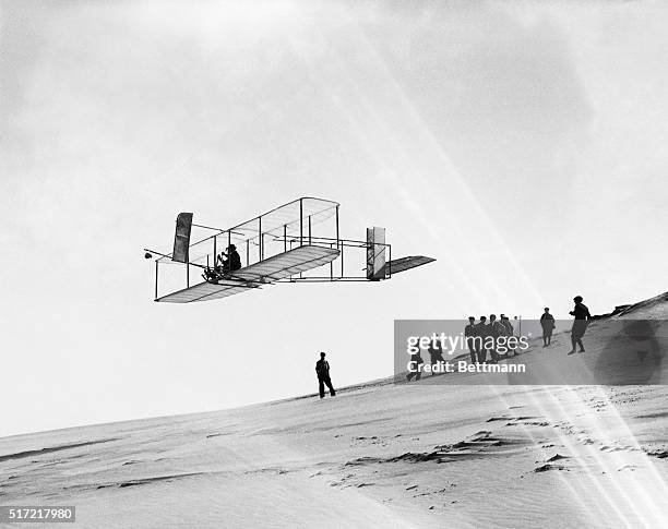 Orville Wright flies a glider over Kill Devil Hills.