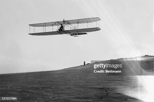 Alex Ogilvie watches Orville Wright glide over the Kill Devil Hills,