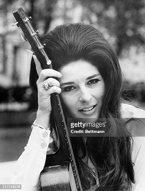 London, England- Glamourous American singing star pictured with her guitar in London, May 27, is Bobbie Gentry, who has arrived in the United Kingdom...