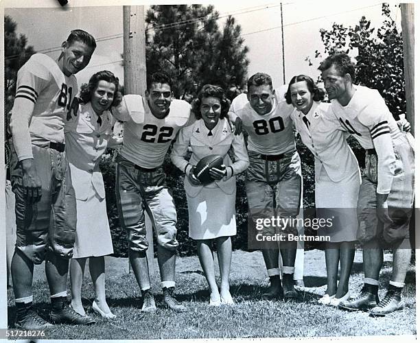 Back in the days before the war, a beautiful co-ed and a football player always made a good picture. Now things are a bit different as the above...