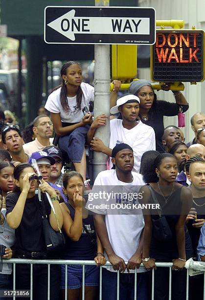 Fans of US pop singer Aaliyah watch from across the street from the St. Ignatius Loyola Church following funeral services in New York on 31 August...