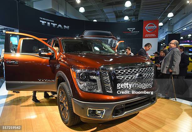Attendees view the 2017 Nissan Motor Co. Titan pickup truck during the 2016 New York International Auto Show in New York, U.S., on Thursday, March...
