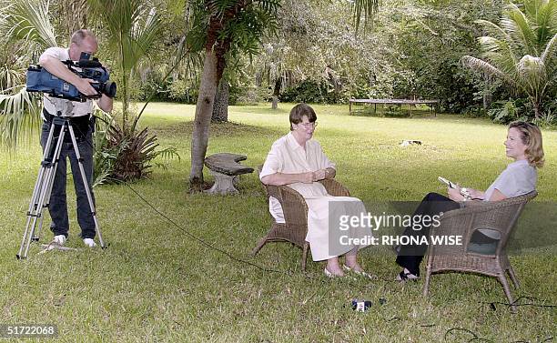 Former US attorney general Janet Reno speaks with members of the media at her home in Miami 04 September 2001 to announce she would be running for...