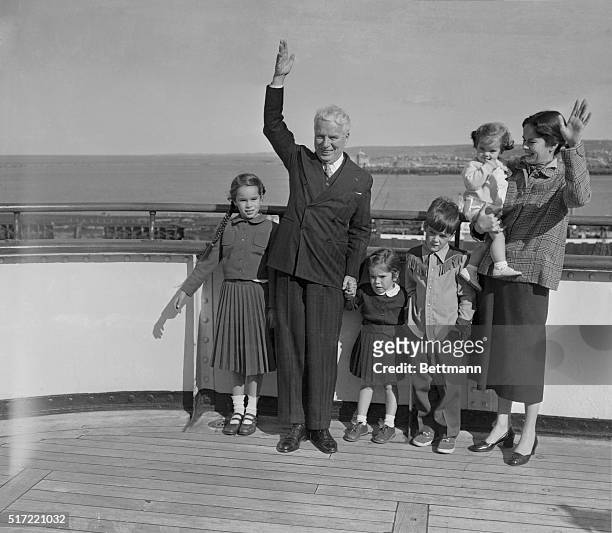Chaplin Arrives in France. Cherbourg, France: Charles Chaplin waves from deck of the liner Queen Elizabeth, which docked at Cherbourg en route to...