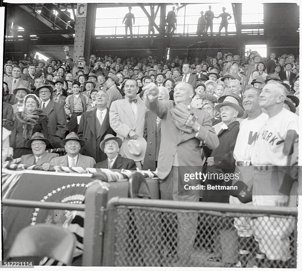 President Eisenhower throws out the first ball at the Washington Senators-New York Yankees game, April 16th, to open up the baseball season in the...