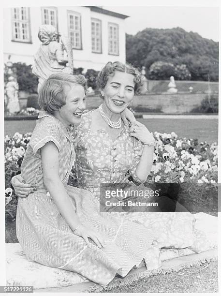 Named Heir to Denmark's Throne. Fredensborg, Denmark: Queen Ingrid of Denmark poses affectionately with her eldest daughter, Margrethe, who, under a...