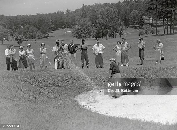 Patty Berg, of St. Andrews, Illinois, blasts out of the sand trap towards the 15th green, June 17, in second round matches at the Women's Western...