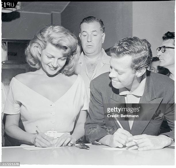 Sign Wedding License. Las Vegas, Nevada: All smiles is film star, Rita Hayworth, as she signs her wedding license at Las Vegas, less than an hour...