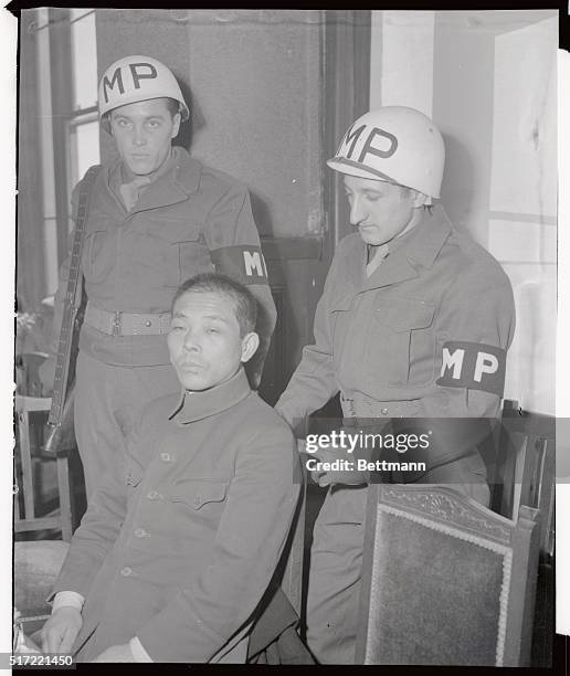 Left to right: two MP's T/5 Richard L. Stephan, of La Cresse, Wisc., Pfc. Frank Di Rienzon of Buffalo, N.Y., and seated in the front of the MP's is...