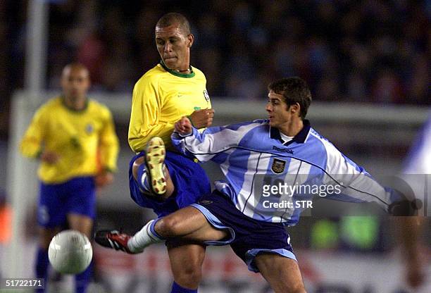 Pablo Aimar of Argentina kicks the ball away from Eduardo Costa of Brazil during their 2002 World Cup Korea-Japan qualification match at Monumental...