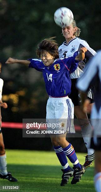 Germany's Nia Kunzer battles for a header with Japan's Mio Otani during the 2001 Nike US Women's Cup 09 September 2001 in Buffalo Grove, Illinois....