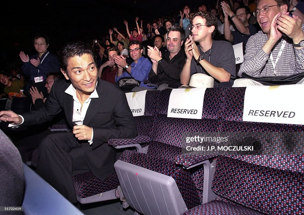 Asian film star Andy Lau takes his seat amid a thr
