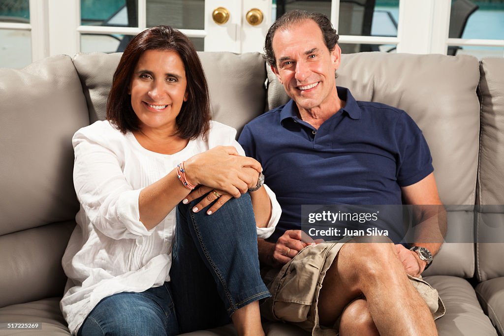 Mature couple sitting on couch