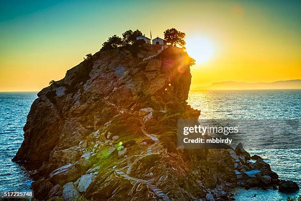rock avec église agios ioannis sur skopelos île au lever du soleil - skopelos photos et images de collection