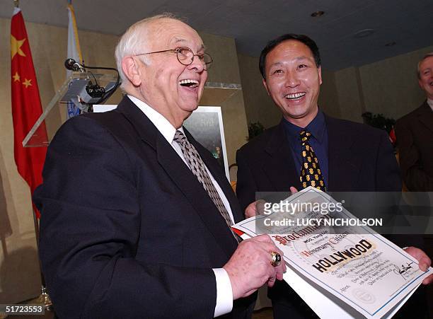 Honorary Mayor of Hollywood Johnny Grant presents Chinese filmmaker Woo Yong Lin, senior executive with the Shanghai Film Studios and China Project...