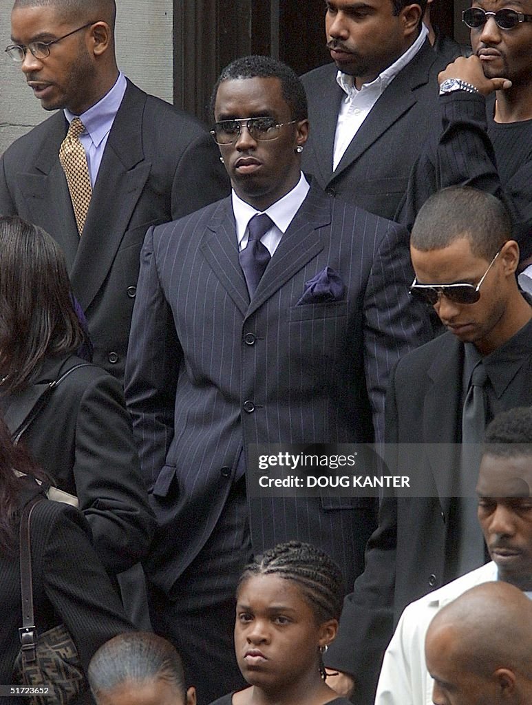 Rapper Sean "Puffy" Combs (C) leaves the funeral o