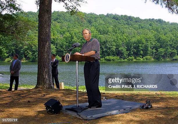 President George W. Bush delivers a speech on enviromental stewardship next to a lake at Oak Mountain State Park near Birmingham, Alabama, before...