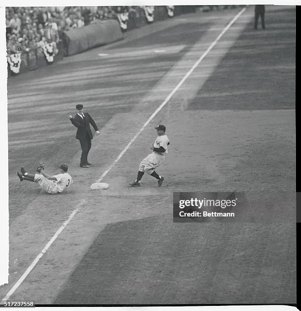 Forced to a stop. Brooklyn, N.Y.: Billy Cox of the Dodgers drops to the ground making a sensational stop of Hank Bauer's grounder with bases loaded...