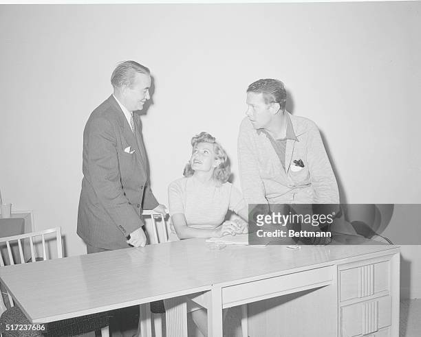 Singer Dick Haymes and screen beauty Rita Hayworth confer with attorney Bartley Crum on their marriage plans at Las Vegas September 19th The couple's...