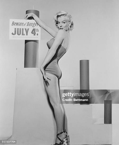 Hollywood's sizzling blond bombshell, Marilyn Monroe, advises to "Beware of Danger" while celebrating on the Fourth of July.