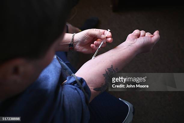 Heroin user injects himself on March 23, 2016 in New London, CT. Communities nationwide are struggling with the unprecidented heroin and opioid pain...