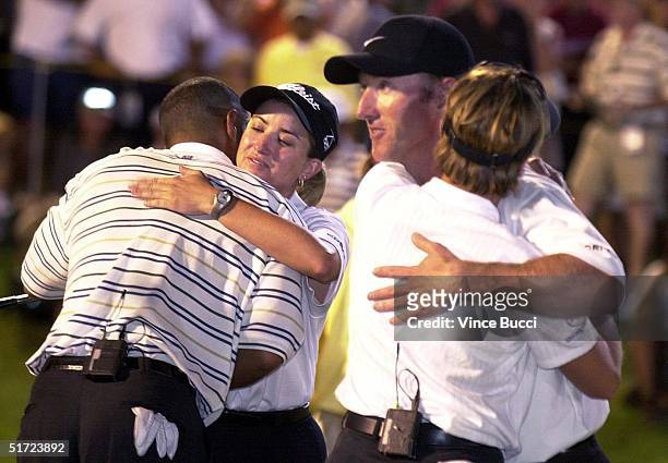 Annika Sorenstam hugs David Duval as Tiger Woods hugs Karrie Webb at the end of the Lincoln Financial Group Battle at Big Horn golfing event at the...