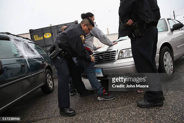 New London police officers search a suspect for heroin on March 14, 2016 in New London, CT. Police say an increasing number of suburban addicts are...