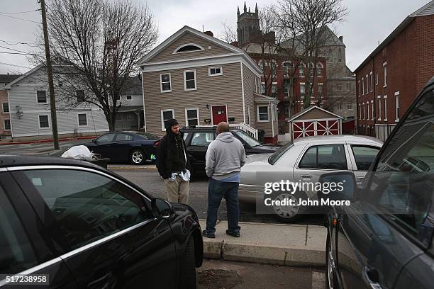 Plainclothed narcotics officer speaks to an addict on March 14, 2016 in New London, CT. Police say an increasing number of suburban addicts are...