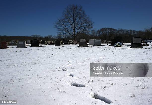 Snow covers a cemetery on March 22, 2016 in Gloucester, MA. Gloucester and communities across New England are struggling with an epidemic of overdose...