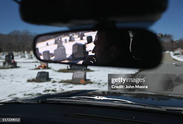 Gloucester police sergeant Jeremiah Nicastro patrols through a cemetery after visiting the grave of a relative that died of heroin overdose on March...