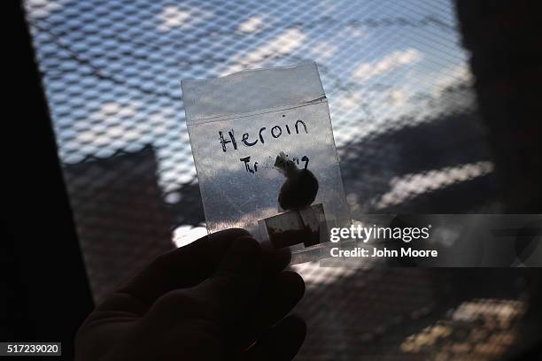 Police officer holds bags of heroin confiscated as evidence on March 22, 2016 in Gloucester, MA. Last year Gloucester created the Angel Program,...