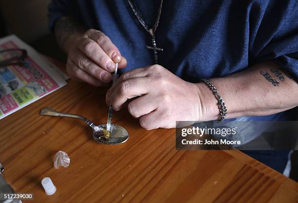 Heroin user prepares to inject himself on March 23, 2016 in New London, CT. Communities nationwide are struggling with the unprecidented heroin and...