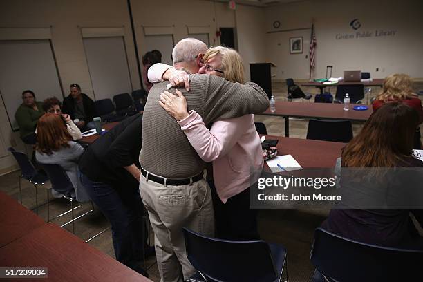 Parents of heroin and opioid addicts embrace during a family addiction support group on March 23, 2016 in Groton, CT. The group Communities Speak Out...