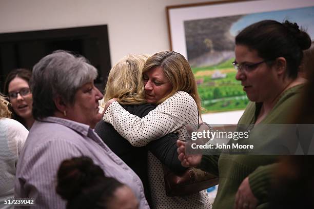 Lisa Cote Johns, , who's son died of a heroin overdose, embraces another parent during a family addiction support group on March 23, 2016 in Groton,...