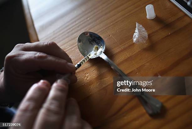 Heroin user prepares to inject himself on March 23, 2016 in New London, CT. Communities nationwide are struggling with the unprecidented heroin and...