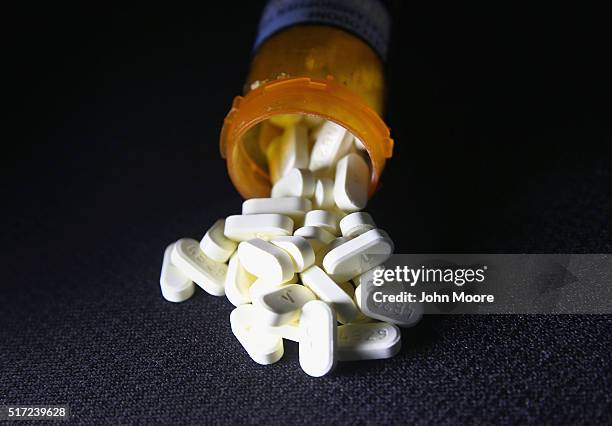 Oxycodone pain pills prescribed for a patient with chronic pain lie on display on March 23, 2016 in Norwich, CT. Communities nationwide are...